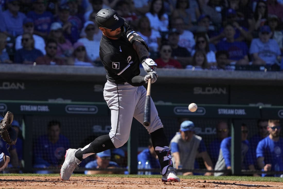 Mar 1, 2024; Mesa, Arizona, USA; Chicago White Sox right fielder Kevin Pillar (12) hits a double against the Chicago Cubs during the third inning at Sloan Park. Mandatory Credit: Rick Scuteri-USA TODAY Sports