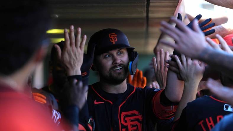 Mar 1, 2024; Scottsdale, Arizona, USA; San Francisco Giants first baseman J.D. Davis (7) celebrates with teammates after hitting a home run against the Texas Rangers during the second inning at Scottsdale Stadium. Mandatory Credit: Joe Camporeale-USA TODAY Sports