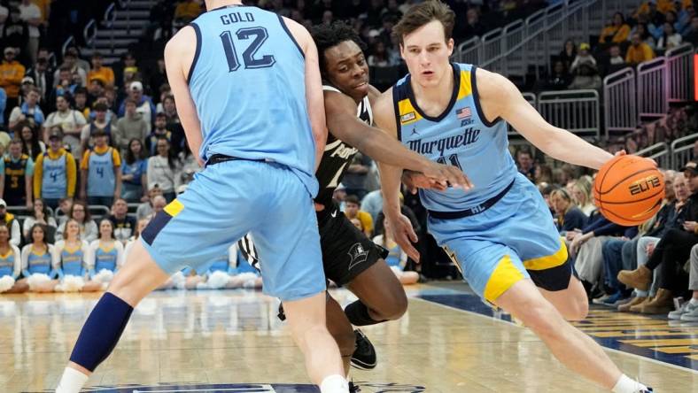 Marquette guard Tyler Kolek (11) takes advantage of a pick by forward Ben Gold (12) on guard Jayden Pierre (1) during the first half of their game Wednesday, February 28, 2024 at Fiserv Forum in Milwaukee, WisconsinMark Hoffman/Milwaukee Journal Sentinel