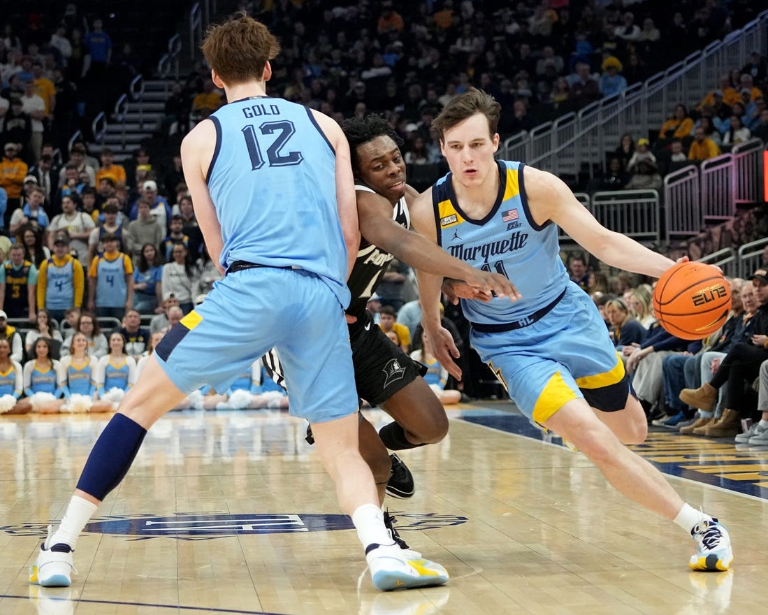 Marquette guard Tyler Kolek (11) takes advantage of a pick by forward Ben Gold (12) on guard Jayden Pierre (1) during the first half of their game Wednesday, February 28, 2024 at Fiserv Forum in Milwaukee, WisconsinMark Hoffman/Milwaukee Journal Sentinel