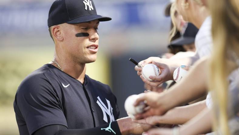 Mar 1, 2024; Tampa, Florida, USA; New York Yankees center fielder Aaron Judge (99) signs autographs before a game against the Toronto Blue Jays at George M. Steinbrenner Field. Mandatory Credit: Nathan Ray Seebeck-USA TODAY Sports