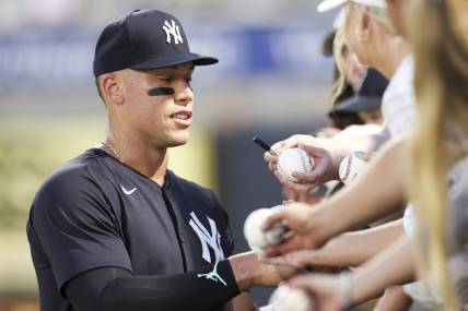 Mar 1, 2024; Tampa, Florida, USA; New York Yankees center fielder Aaron Judge (99) signs autographs before a game against the Toronto Blue Jays at George M. Steinbrenner Field. Mandatory Credit: Nathan Ray Seebeck-USA TODAY Sports