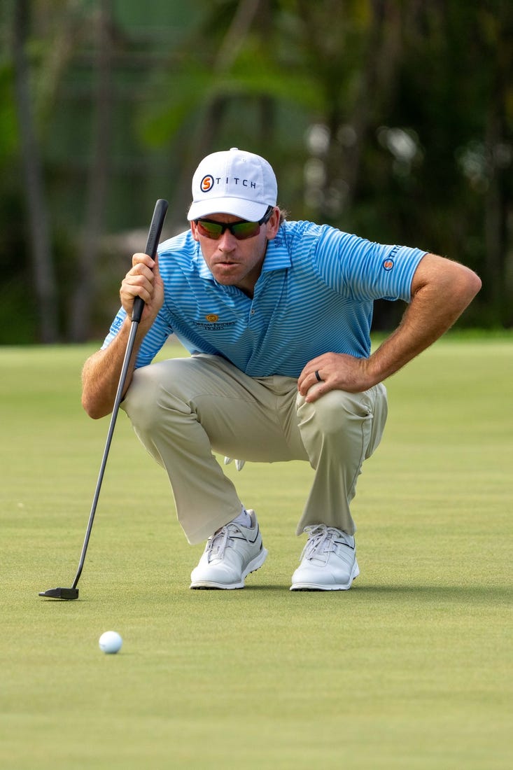 January 13, 2024; Honolulu, Hawaii, USA; Ben Kohles lines up his putt on the first hole during the third round of the Sony Open in Hawaii golf tournament at Waialae Country Club. Mandatory Credit: Kyle Terada-USA TODAY Sports