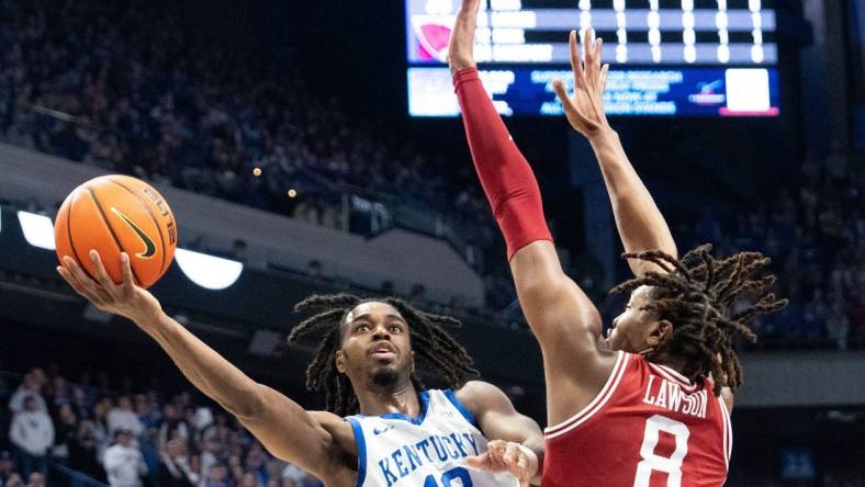 Kentucky Wildcats guard Antonio Reeves (12) goes for a layup against Arkansas Razorbacks forward Chandler Lawson (8) during their game on Saturday, March 2, 2024 at Rupp Arena.