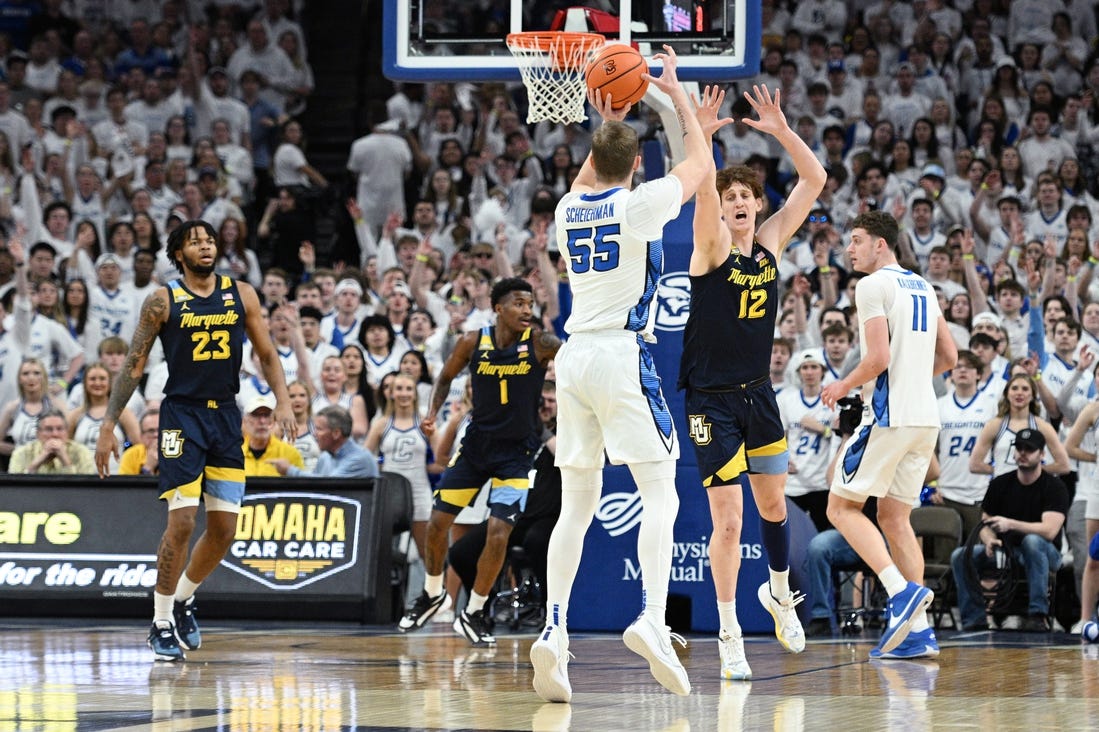 Mar 2, 2024; Omaha, Nebraska, USA; Creighton Bluejays guard Baylor Scheierman (55) scores a three point basket against Marquette Golden Eagles forward Ben Gold (12) in the first half at CHI Health Center Omaha. Mandatory Credit: Steven Branscombe-USA TODAY Sports