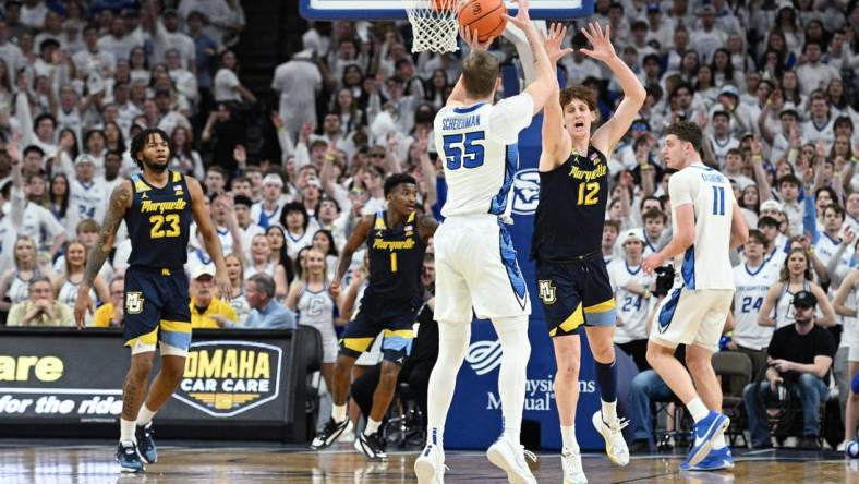 Mar 2, 2024; Omaha, Nebraska, USA; Creighton Bluejays guard Baylor Scheierman (55) scores a three point basket against Marquette Golden Eagles forward Ben Gold (12) in the first half at CHI Health Center Omaha. Mandatory Credit: Steven Branscombe-USA TODAY Sports