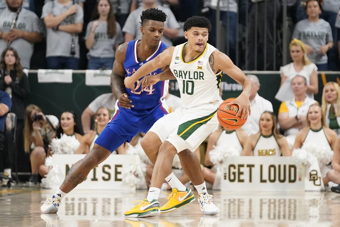 Mar 2, 2024; Waco, Texas, USA; Baylor Bears guard RayJ Dennis (10) is defended by Kansas Jayhawks forward K.J. Adams Jr. (24) during the first half at Paul and Alejandra Foster Pavilion. Mandatory Credit: Raymond Carlin III-USA TODAY Sports