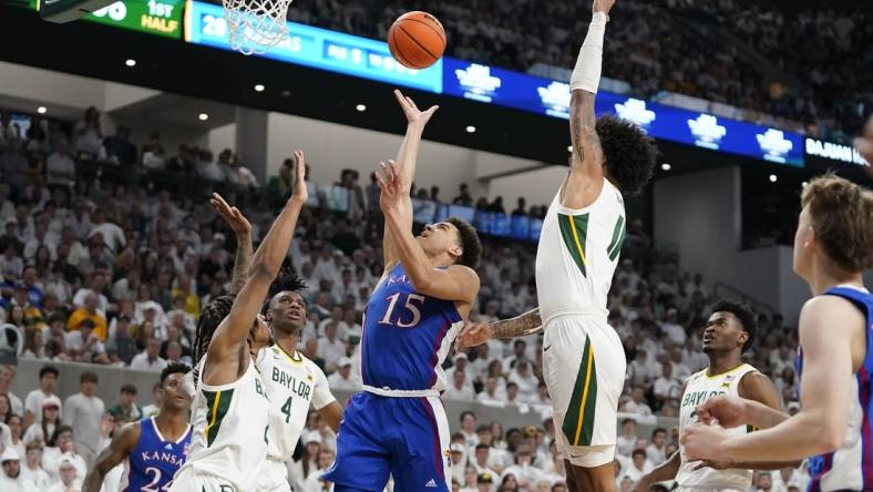 Mar 2, 2024; Waco, Texas, USA; Kansas Jayhawks guard Kevin McCullar Jr. (15) shoots over Baylor Bears guard Jayden Nunn (2) during the first half at Paul and Alejandra Foster Pavilion. Mandatory Credit: Raymond Carlin III-USA TODAY Sports