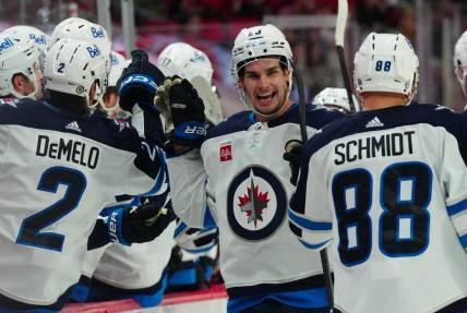 Mar 2, 2024; Raleigh, North Carolina, USA; Winnipeg Jets center Sean Monahan (23) is congratulated after his goal against the Carolina Hurricanes during the third period at PNC Arena. Mandatory Credit: James Guillory-USA TODAY Sports