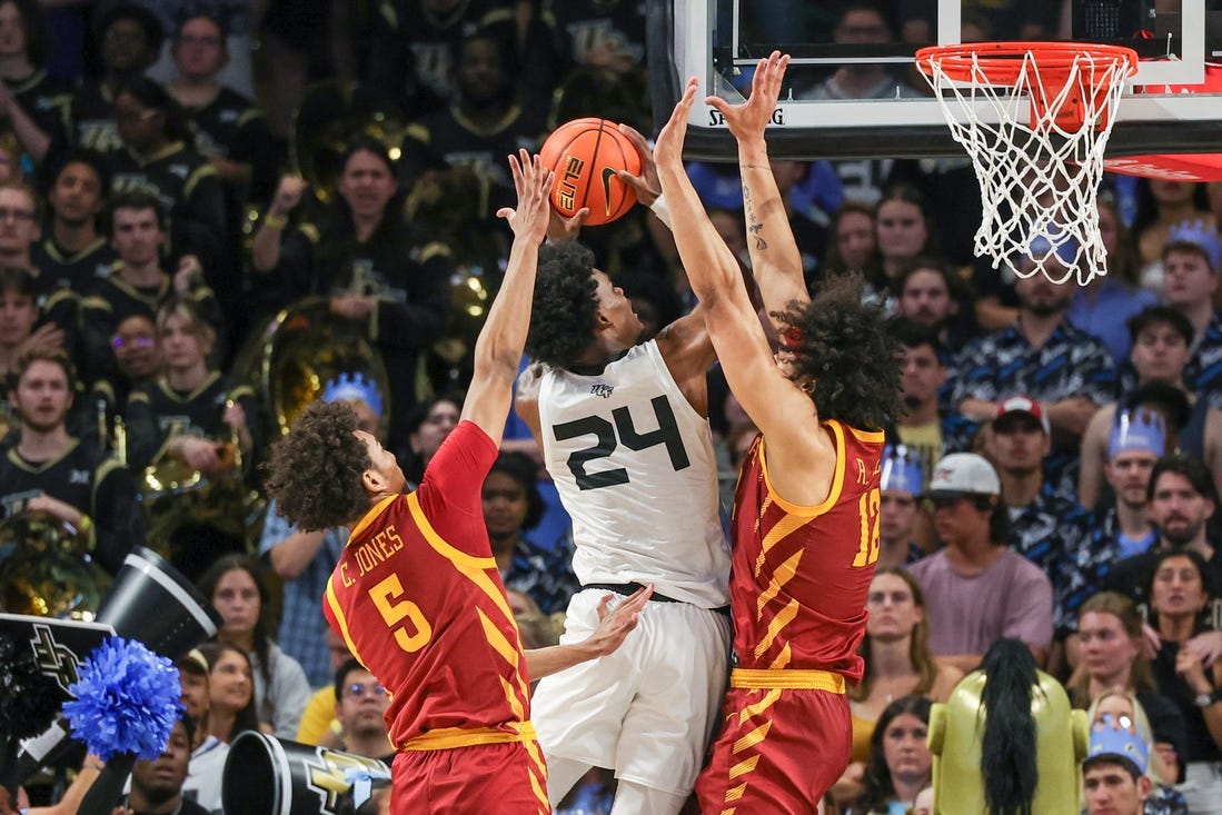 Mar 2, 2024; Orlando, Florida, USA; UCF Knights guard Jaylin Sellers (24) goes to the basket against Iowa State Cyclones guard Curtis Jones (5) and forward Robert Jones (12) during the first half at Addition Financial Arena. Mandatory Credit: Mike Watters-USA TODAY Sports