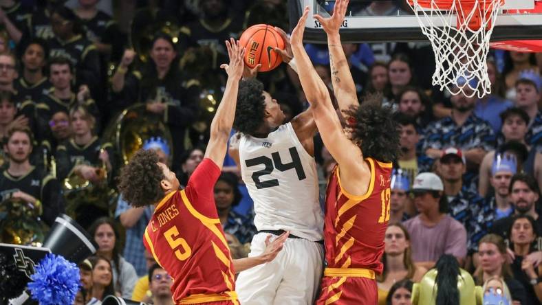 Mar 2, 2024; Orlando, Florida, USA; UCF Knights guard Jaylin Sellers (24) goes to the basket against Iowa State Cyclones guard Curtis Jones (5) and forward Robert Jones (12) during the first half at Addition Financial Arena. Mandatory Credit: Mike Watters-USA TODAY Sports