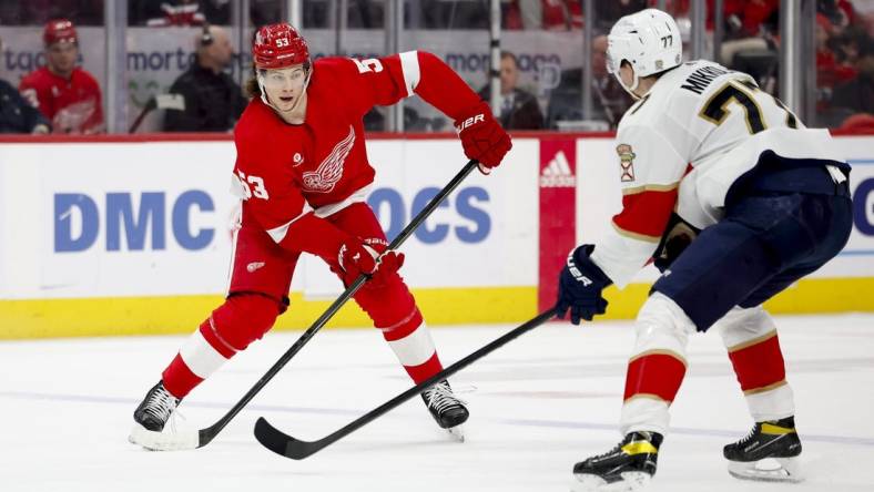 Mar 2, 2024; Detroit, Michigan, USA; Detroit Red Wings defenseman Moritz Seider (53) controls the puck while defended by Florida Panthers defenseman Niko Mikkola (77) in the second period at Little Caesars Arena. Mandatory Credit: Rick Osentoski-USA TODAY Sports defense