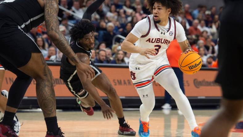 Auburn Tigers guard Tre Donaldson (3) drives the ball as Auburn Tigers take on Mississippi State Bulldogs at Neville Arena in Auburn, Ala., on Saturday, March 2, 2024. Auburn Tigers lead Mississippi State Bulldogs 39-22 at halftime.