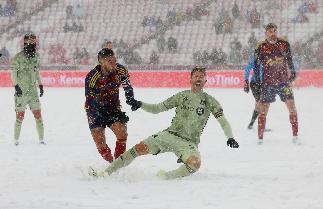 Mar 2, 2024; Sandy, Utah, USA; LAFC defender Ryan Hollingshead (24) is taken down by Real Salt Lake forward Cristian Arango (9) at America First Field. Mandatory Credit: Rob Gray-USA TODAY Sports