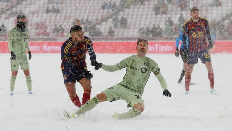 Mar 2, 2024; Sandy, Utah, USA; LAFC defender Ryan Hollingshead (24) is taken down by Real Salt Lake forward Cristian Arango (9) at America First Field. Mandatory Credit: Rob Gray-USA TODAY Sports