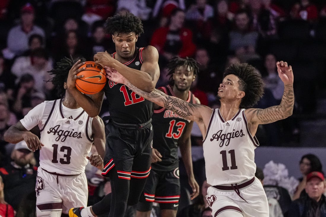 Mar 2, 2024; Athens, Georgia, USA; Georgia Bulldogs forward Matthew-Alexander Moncrieffe (12) grabs a rebound in front of Texas A&M Aggies forward Andersson Garcia (11) during the first half at Stegeman Coliseum. Mandatory Credit: Dale Zanine-USA TODAY Sports