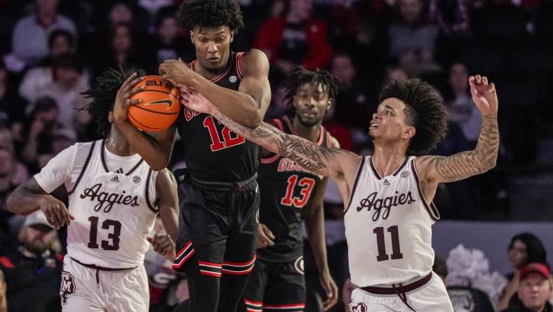 Mar 2, 2024; Athens, Georgia, USA; Georgia Bulldogs forward Matthew-Alexander Moncrieffe (12) grabs a rebound in front of Texas A&M Aggies forward Andersson Garcia (11) during the first half at Stegeman Coliseum. Mandatory Credit: Dale Zanine-USA TODAY Sports