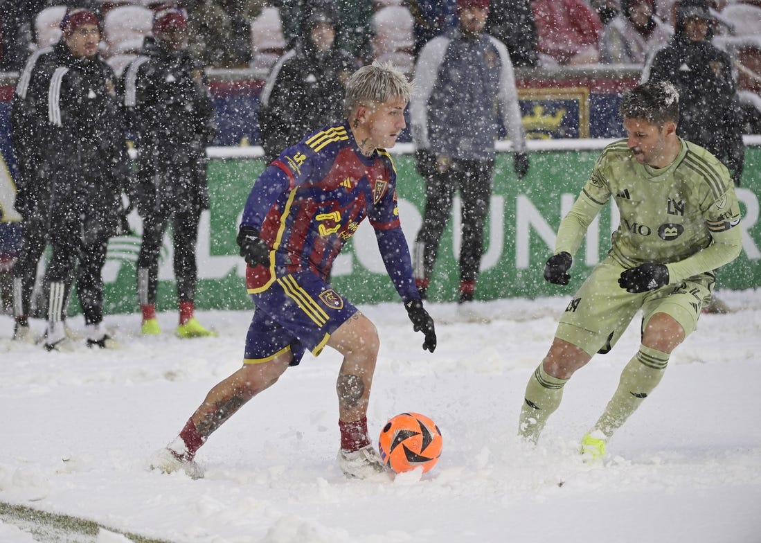 Mar 2, 2024; Sandy, Utah, USA;  Real Salt Lake midfielder Diego Luna (8) is defended by LAFC defender Ryan Hollingshead (24) at America First Field. Mandatory Credit: Christopher Creveling-USA TODAY Sports