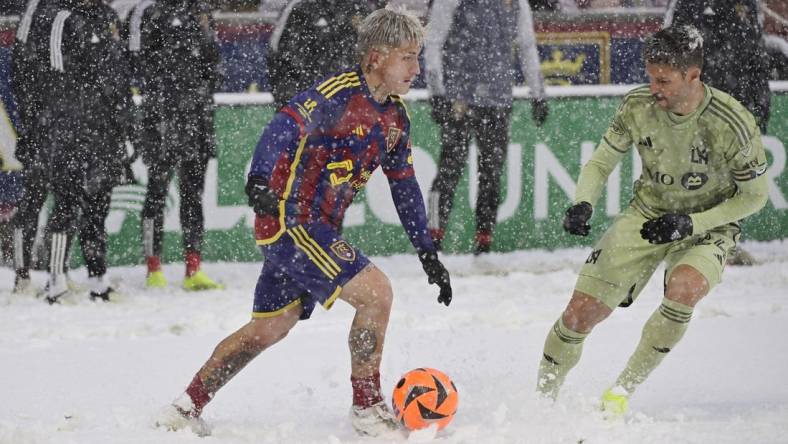 Mar 2, 2024; Sandy, Utah, USA;  Real Salt Lake midfielder Diego Luna (8) is defended by LAFC defender Ryan Hollingshead (24) at America First Field. Mandatory Credit: Christopher Creveling-USA TODAY Sports