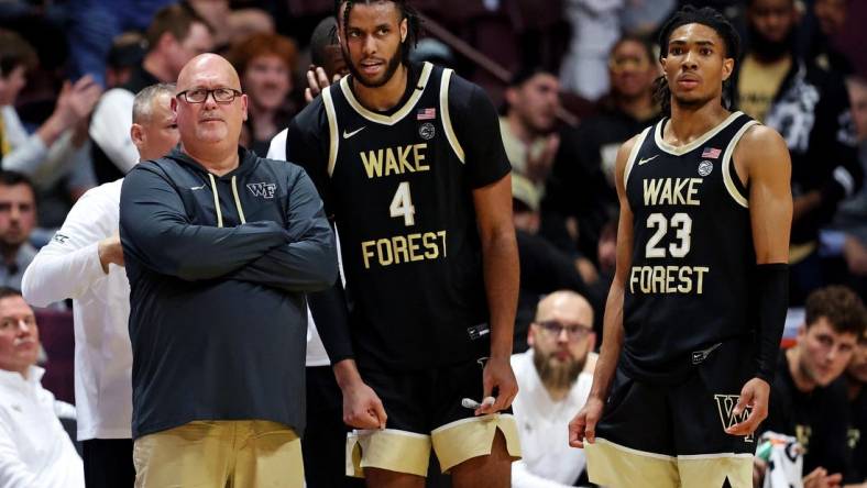 Mar 2, 2024; Blacksburg, Virginia, USA; Wake Forest Demon Deacons head coach Steve Forbes talks with Wake Forest Demon Deacons forward Efton Reid III (4) and guard Hunter Sallis (23) during the second half of the game against the Virginia Tech Hokies at Cassell Coliseum. Mandatory Credit: Peter Casey-USA TODAY Sports