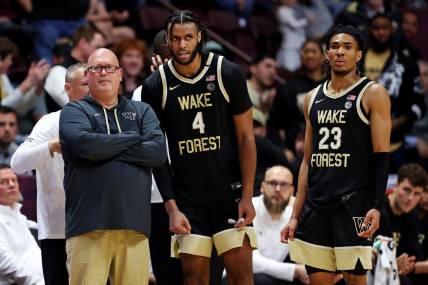 Mar 2, 2024; Blacksburg, Virginia, USA; Wake Forest Demon Deacons head coach Steve Forbes talks with Wake Forest Demon Deacons forward Efton Reid III (4) and guard Hunter Sallis (23) during the second half of the game against the Virginia Tech Hokies at Cassell Coliseum. Mandatory Credit: Peter Casey-USA TODAY Sports