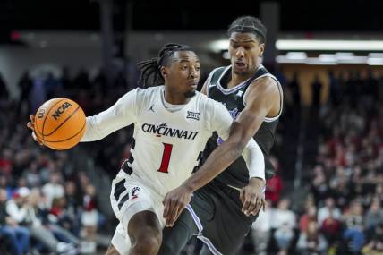 Mar 2, 2024; Cincinnati, Ohio, USA;  Cincinnati Bearcats guard Day Day Thomas drives to the basket against Kansas State Wildcats forward David N'Guessan (1) in the first half at Fifth Third Arena. Mandatory Credit: Aaron Doster-USA TODAY Sports