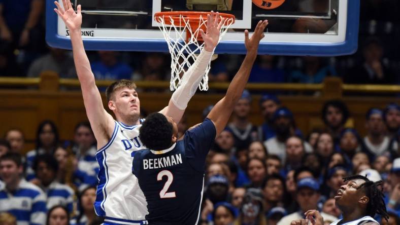 Mar 2, 2024; Durham, North Carolina, USA; Virginia Cavaliers guard Reece Beekman (2) shoots over Duke Blue Devils center Kyle Filipowski (30) during the second half at Cameron Indoor Stadium. Mandatory Credit: Rob Kinnan-USA TODAY Sports