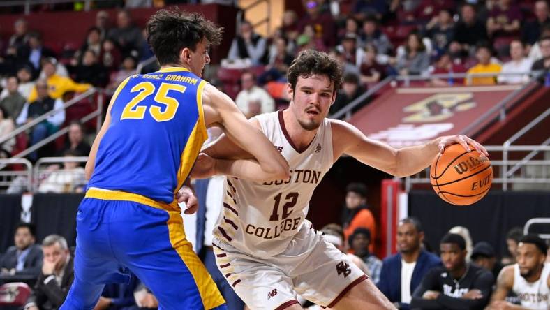 Mar 2, 2024; Chestnut Hill, Massachusetts, USA; Boston College Eagles forward Quinten Post (12) drives to the basket against Pittsburgh Panthers forward Guillermo Diaz Graham (25) during the second half at Conte Forum. Mandatory Credit: Eric Canha-USA TODAY Sports