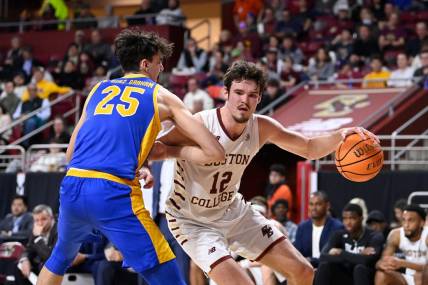 Mar 2, 2024; Chestnut Hill, Massachusetts, USA; Boston College Eagles forward Quinten Post (12) drives to the basket against Pittsburgh Panthers forward Guillermo Diaz Graham (25) during the second half at Conte Forum. Mandatory Credit: Eric Canha-USA TODAY Sports