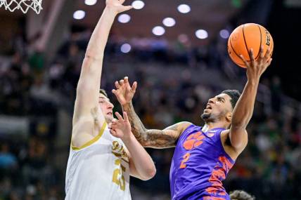 Mar 2, 2024; South Bend, Indiana, USA; Clemson Tigers guard Dillon Hunter (2) goes up for a shot as Notre Dame Fighting Irish forward Matt Zona (25) defends in the first half at the Purcell Pavilion. Mandatory Credit: Matt Cashore-USA TODAY Sports