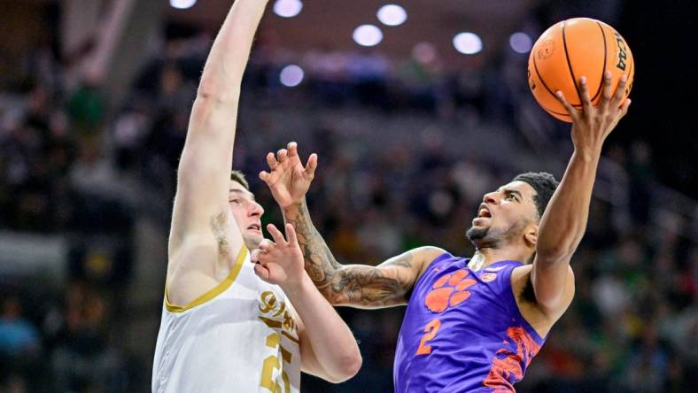 Mar 2, 2024; South Bend, Indiana, USA; Clemson Tigers guard Dillon Hunter (2) goes up for a shot as Notre Dame Fighting Irish forward Matt Zona (25) defends in the first half at the Purcell Pavilion. Mandatory Credit: Matt Cashore-USA TODAY Sports