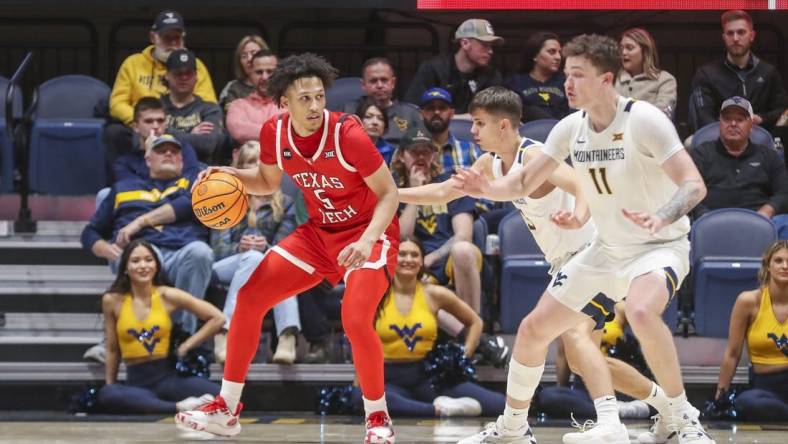 Mar 2, 2024; Morgantown, West Virginia, USA; Texas Tech Red Raiders guard Darrion Williams (5) backs down West Virginia Mountaineers guard Kerr Kriisa (3) during the second half at WVU Coliseum. Mandatory Credit: Ben Queen-USA TODAY Sports