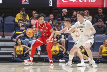 Mar 2, 2024; Morgantown, West Virginia, USA; Texas Tech Red Raiders guard Darrion Williams (5) backs down West Virginia Mountaineers guard Kerr Kriisa (3) during the second half at WVU Coliseum. Mandatory Credit: Ben Queen-USA TODAY Sports