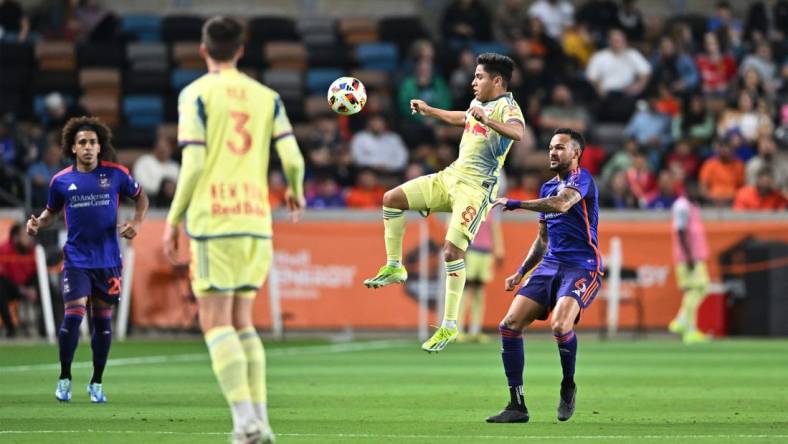 Mar 2, 2024; Houston, Texas, USA; New York Red Bulls midfielder Frankie Amaya (8) plays the ball defend by Houston Dynamo FC midfielder Artur (6) in the first half  at Shell Energy Stadium. Mandatory Credit: Maria Lysaker-USA TODAY Sports