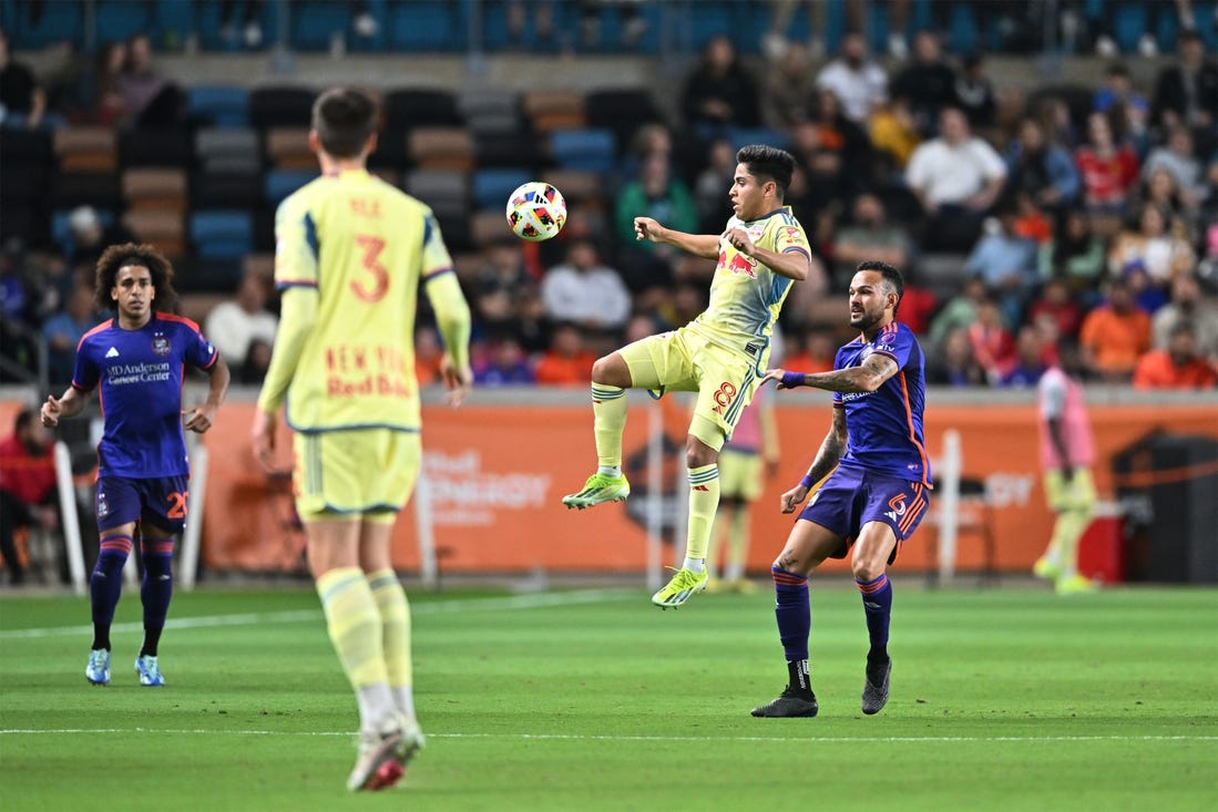 Mar 2, 2024; Houston, Texas, USA; New York Red Bulls midfielder Frankie Amaya (8) plays the ball defend by Houston Dynamo FC midfielder Artur (6) in the first half  at Shell Energy Stadium. Mandatory Credit: Maria Lysaker-USA TODAY Sports