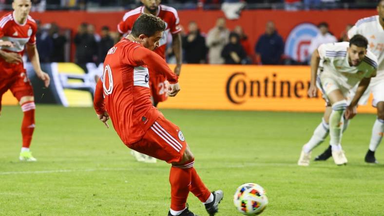 Mar 2, 2024; Chicago, Illinois, USA; Chicago Fire FC midfielder Xherdan Shaqiri (10) kicks and scores a goal against the FC Cincinnati in the first half at Soldier Field. Mandatory Credit: Mike Dinovo-USA TODAY Sports