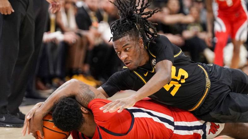 Mar 2, 2024; Columbia, Missouri, USA; Mississippi Rebels guard Brandon Murray (0) and Missouri Tigers guard Sean East II (55) scramble for a loose ball during the first half at Mizzou Arena. Mandatory Credit: Denny Medley-USA TODAY Sports