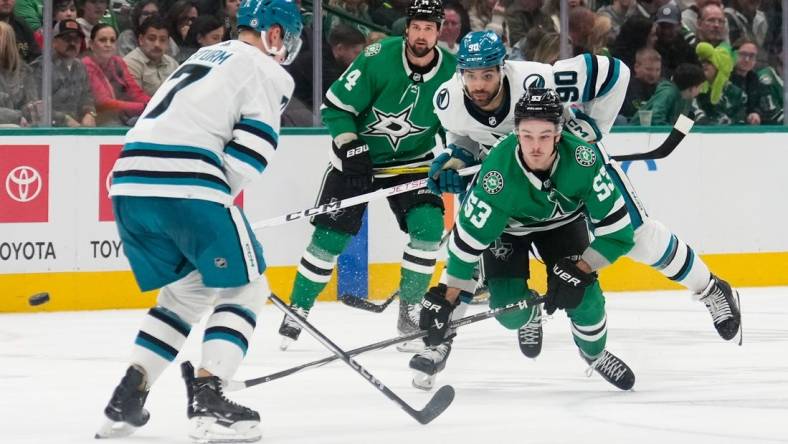 Mar 2, 2024; Dallas, Texas, USA;  Dallas Stars center Wyatt Johnston (53) and San Jose Sharks right wing Justin Bailey (90) chase the puck during the second period at American Airlines Center. Mandatory Credit: Chris Jones-USA TODAY Sports