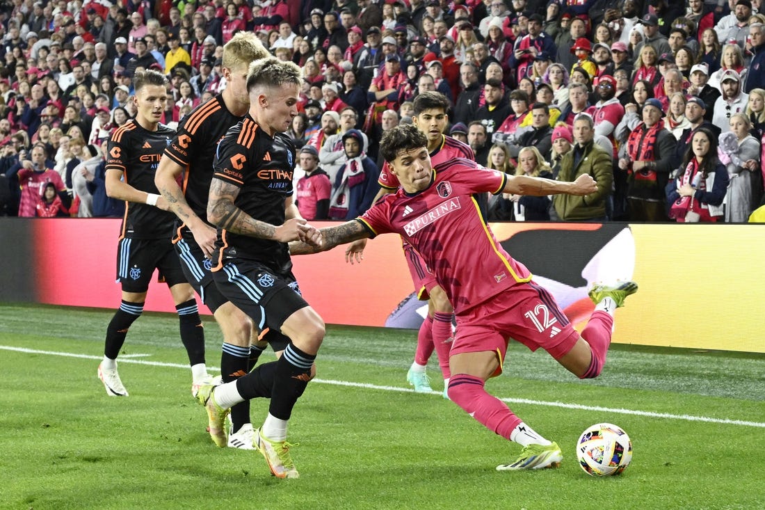 Mar 2, 2024; St. Louis, Missouri, USA;  St. Louis CITY SC midfielder Celio Pompeu (12) controls the ball against New York City FC defender Mitja Ilenic (35) in the first half at CITYPARK. Mandatory Credit: Jeff Le-USA TODAY Sports