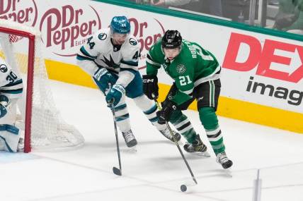 Mar 2, 2024; Dallas, Texas, USA;  Dallas Stars left wing Jason Robertson (21) skates with the puck as San Jose Sharks defenseman Marc-Edouard Vlasic (44) defends during the third period at American Airlines Center. Mandatory Credit: Chris Jones-USA TODAY Sports