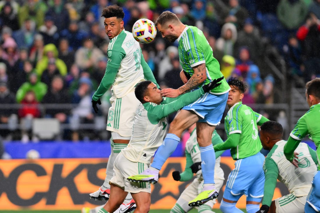 Mar 2, 2024; Seattle, Washington, USA; Seattle Sounders FC forward Jordan Morris (13) heads the ball against Austin FC midfielder Dani Pereira (6) during the first half at Lumen Field. Mandatory Credit: Steven Bisig-USA TODAY Sports