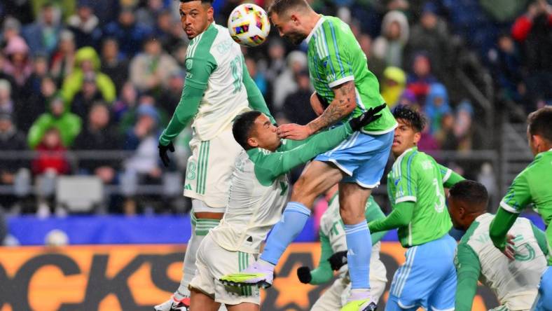 Mar 2, 2024; Seattle, Washington, USA; Seattle Sounders FC forward Jordan Morris (13) heads the ball against Austin FC midfielder Dani Pereira (6) during the first half at Lumen Field. Mandatory Credit: Steven Bisig-USA TODAY Sports