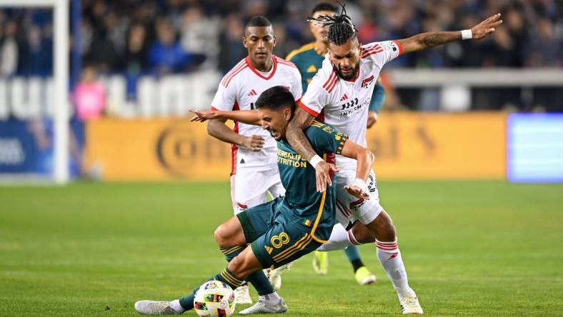 Mar 2, 2024; San Jose, California, USA; San Jose Earthquakes forward Will Richmond (20) battles for the ball against LA Galaxy midfielder Mark Delgado (8) during the first half at PayPal Park. Mandatory Credit: Robert Edwards-USA TODAY Sports