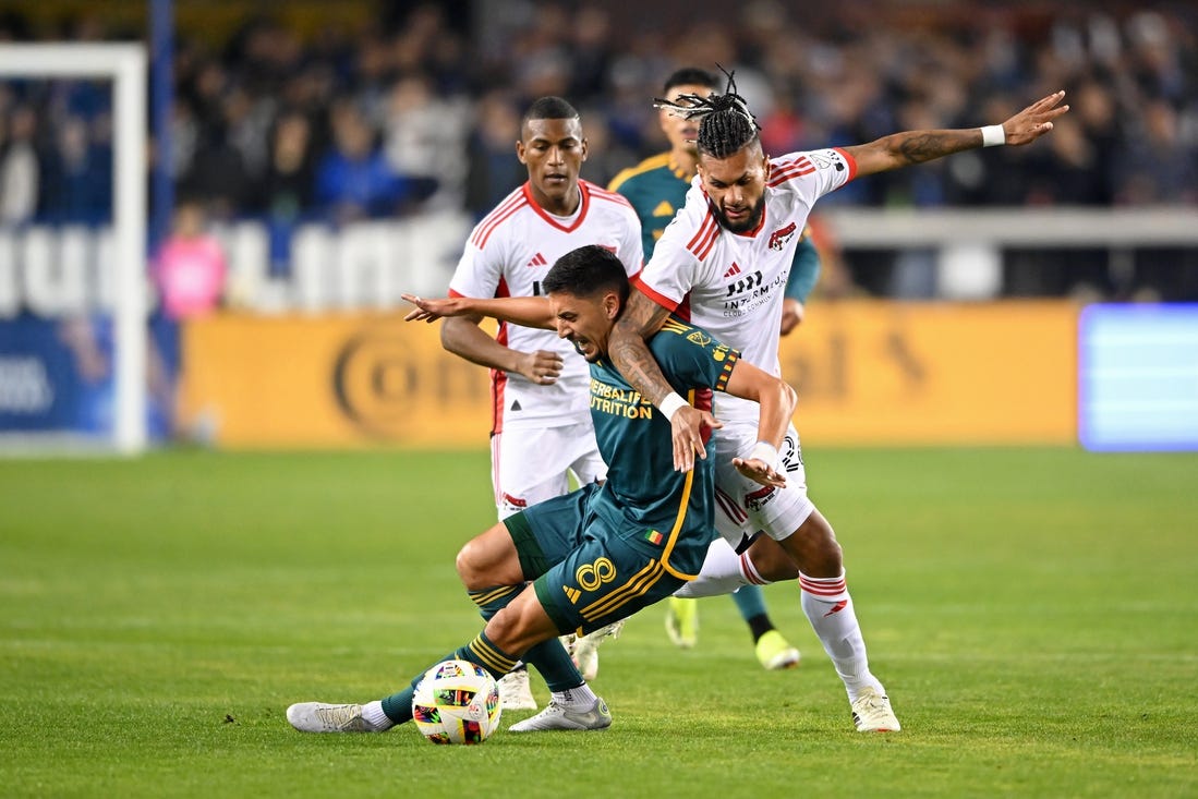 Mar 2, 2024; San Jose, California, USA; San Jose Earthquakes forward Will Richmond (20) battles for the ball against LA Galaxy midfielder Mark Delgado (8) during the first half at PayPal Park. Mandatory Credit: Robert Edwards-USA TODAY Sports