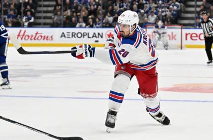 Mar 2, 2024; Toronto, Ontario, CAN; New York Rangers forward Chris Kreider (20) shoots the puck against the Toronto Maple Leafs in the second period at Scotiabank Arena. Mandatory Credit: Dan Hamilton-USA TODAY Sports