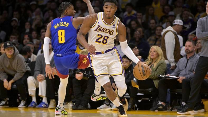 Mar 2, 2024; Los Angeles, California, USA;  Los Angeles Lakers forward Rui Hachimura (28) drives past Denver Nuggets guard Christian Braun (0) in the second half at Crypto.com Arena. Mandatory Credit: Jayne Kamin-Oncea-USA TODAY Sports