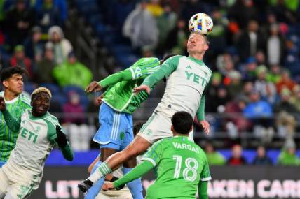 Mar 2, 2024; Seattle, Washington, USA; Austin FC midfielder Alex Ring (8) heads the ball in the second half against the Seattle Sounders FC at Lumen Field. Mandatory Credit: Steven Bisig-USA TODAY Sports