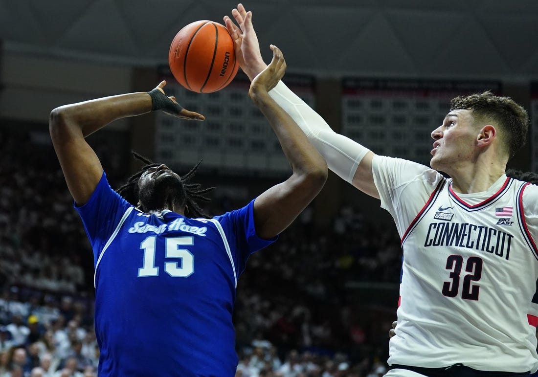 Mar 3, 2024; Storrs, Connecticut, USA; UConn Huskies center Donovan Clingan (32) blocks the shot of Seton Hall Pirates center Jaden Bediako (15) in the first half at Harry A. Gampel Pavilion. Mandatory Credit: David Butler II-USA TODAY Sports