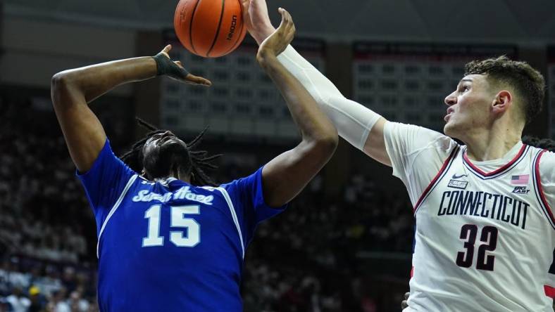 Mar 3, 2024; Storrs, Connecticut, USA; UConn Huskies center Donovan Clingan (32) blocks the shot of Seton Hall Pirates center Jaden Bediako (15) in the first half at Harry A. Gampel Pavilion. Mandatory Credit: David Butler II-USA TODAY Sports