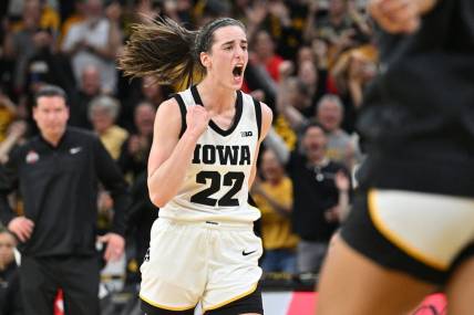 Mar 3, 2024; Iowa City, Iowa, USA; Iowa Hawkeyes guard Caitlin Clark (22) reacts after breaking the NCAA basketball all-time scoring record during the second quarter against the Ohio State Buckeyes. Mandatory Credit: Jeffrey Becker-USA TODAY Sports